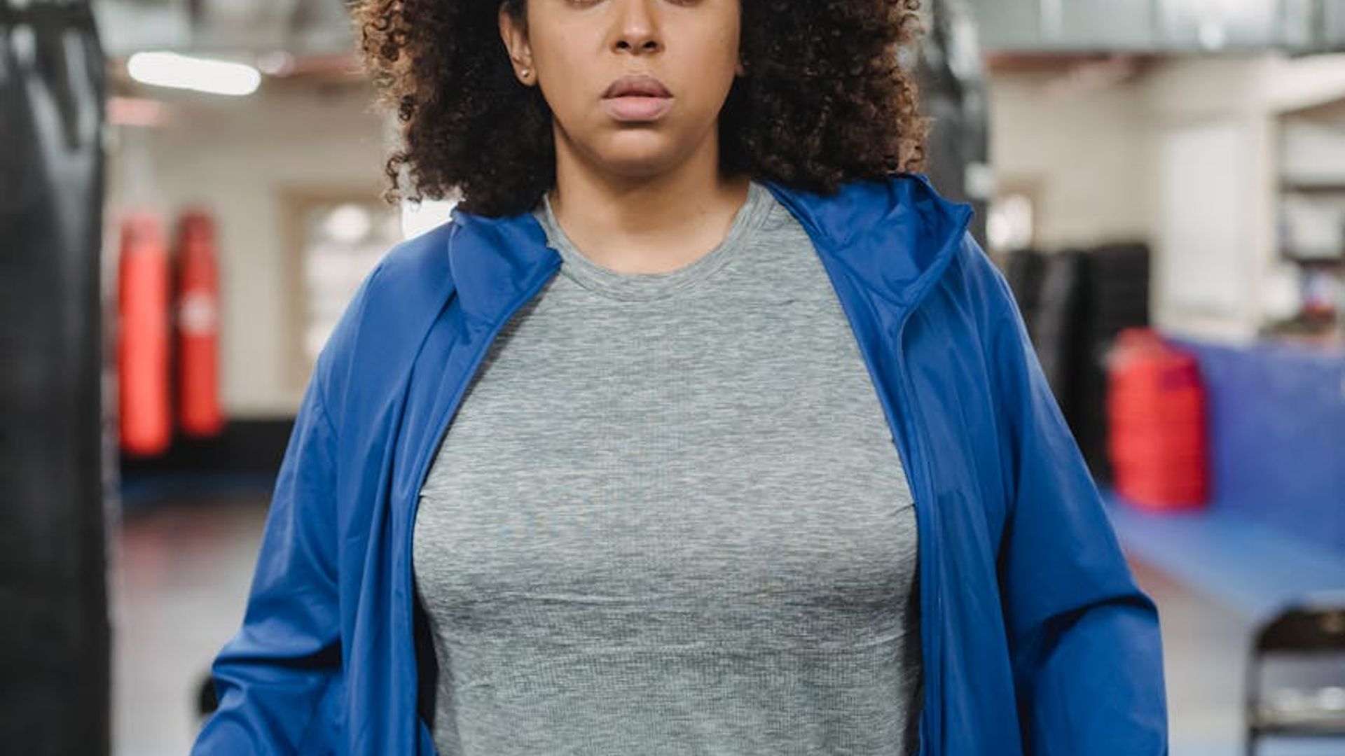 Person doing dynamic cardio movements in a modern gym